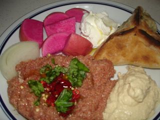 Kibbeh Nayyeh, lebne, spinach pie, pickled turnips, hummus, and onion