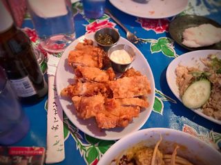 Gai tod naeng noi, friend chicken thighs, served with nam prik noom, a northern thai salsa made with roasted chilis, shallots, garlic and fish sauce