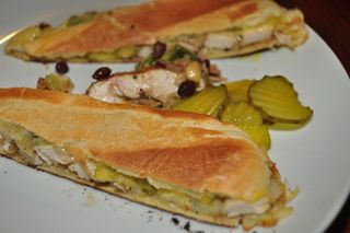 jerked chicken, cheese, pickles, hoagie roll, mustard