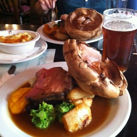 Tucking into roast beef with Yorkshire pud.
