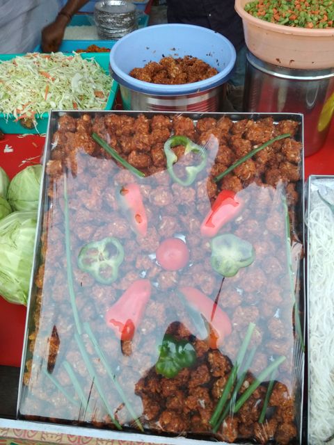 A decorated Veg Manchurian with human face at Hyderabad Bookfair