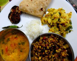 Jeera aloo served with sprouts and dal
